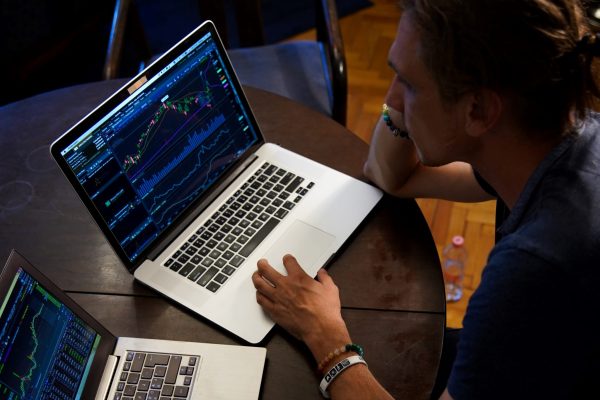 Man looking at data analytics on laptop